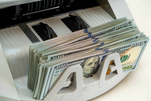 istock Money counting machine in use at a financial office 2194730297