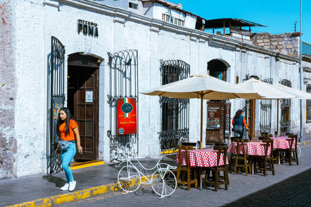 Picturesque streets of Arequipa, Peru, showcasing the city’s iconic colonial architecture built from white volcanic sillar stone. These charming pathways are lined with historic buildings, colorful doorways, and blooming bougainvillea, creating a timeless atmosphere. Wandering through Arequipa’s streets offers a glimpse into its rich cultural heritage and the vibrant life of this UNESCO World Heritage city