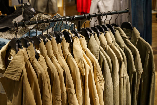 istock Shirts hanging neatly on display in a trendy retail store 2194732090