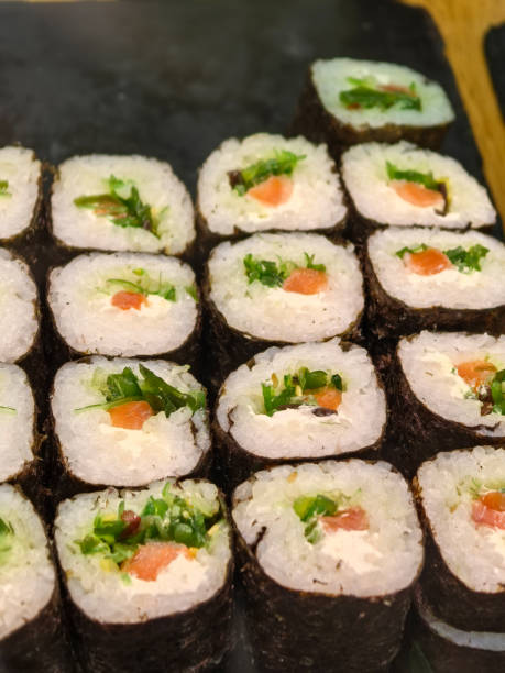 istock Artfully arranged sushi rolls on a wooden platter at a gathering 2194732103