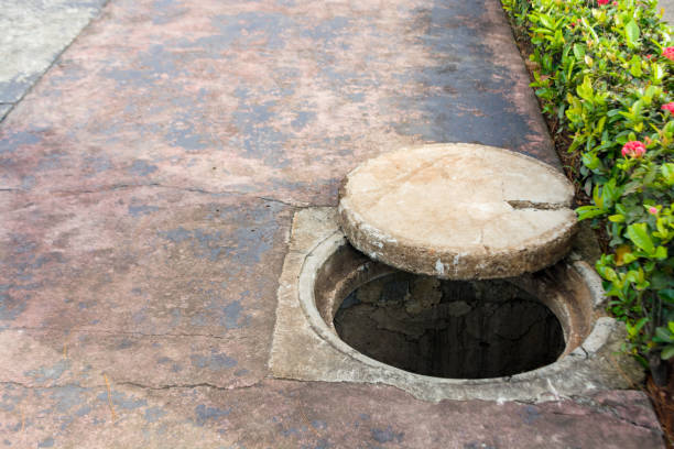 istock Underground water channel hole in the sidewalk 2194735063