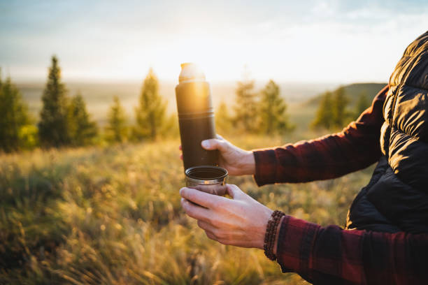 istock Experience the tranquil beauty of sunrise while enjoying a warm beverage, whether its coffee or tea, from your trusty thermos in nature 2194736062