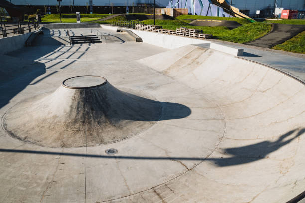 istock A talented skateboarder is performing an impressive trick on a ramp at a lively skate park, showcasing their skills and attracting the attention of onlookers who admire the scene 2194736178