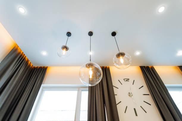 In a charming room with a vintage clock elegantly positioned on the wall, you can also find beautiful curtains gracefully hanging down from the ceiling, adding to the overall ambiance