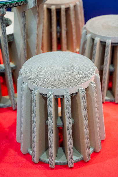 A creatively arranged set of colorful cardboard stools on a vibrant red carpet captures attention, making the room feel lively, energetic, and welcoming to all who enter