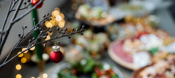 istock A beautifully decorated Christmas tree with sparkling ornaments sits atop a table full of delicious pizzas, creating a joyous festive atmosphere for everyone to enjoy together 2194738963