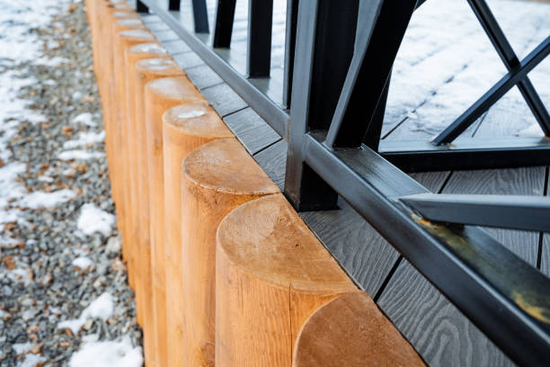 This captivating and visually striking image features a detailed closeup of a beautifully crafted wooden fence, enhanced by a sturdy metal railing that adds both support and visual appeal