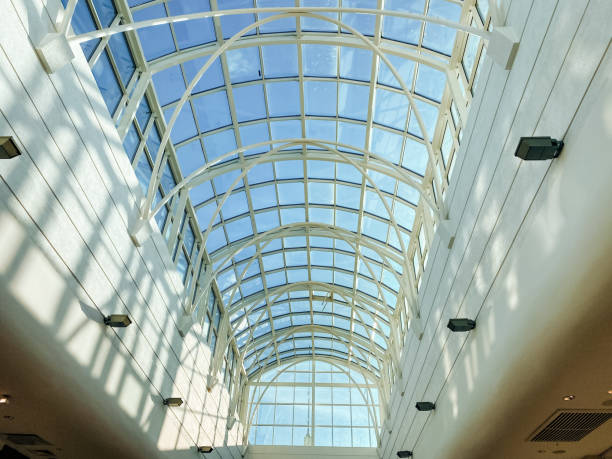 As I stand here, gazing up at the breathtaking glass ceiling above me, I am filled with a profound sense of awe for the stunning architecture that beautifully surrounds me in this vibrant urban area