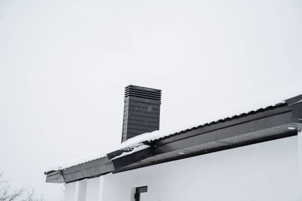 istock A captivating snowy winter landscape prominently features a charming chimney atop a cozy residential house roof, embodying the essence of warmth amidst the cold season 2194741748