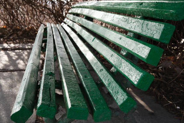 A weathered green bench offers a peaceful spot for reflection outdoors.
