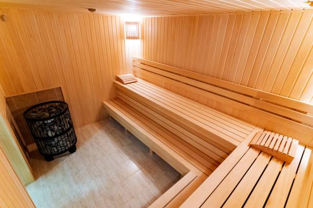 istock This delightful wooden sauna offers comfortable benches crafted from highquality materials, as well as a dependable heater that ensures warmth and relaxation throughout your pleasant visit 2194743569