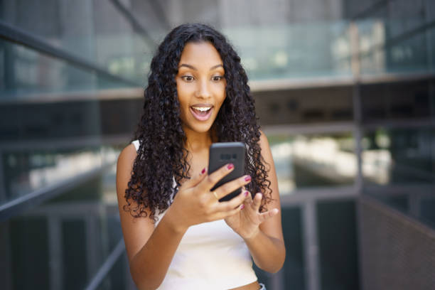 istock An Excited Young Woman Actively Engaging with Her Smartphone in a Trendy Modern Setting 2194743633