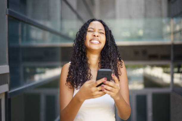 istock A Joyful Young Woman Enjoying Her Time Engaged with a Smartphone Outdoors in Daylight 2194743644