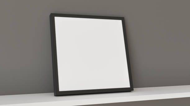 istock An empty black frame resting on a white shelf against a gray wall 2194745840