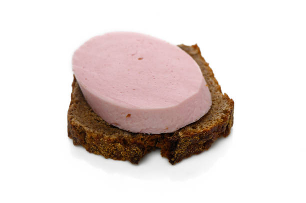 A slice of dark rye bread topped with a creamy pink spread makes for a simple yet satisfying midday meal.