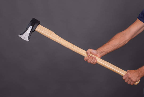 istock A man's hand holding an axe for chopping wood. 2194747685