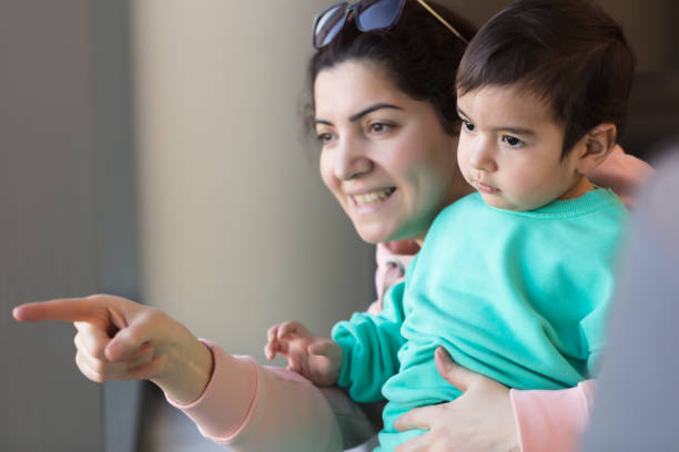 istock Mother and son looking through a window at home 2194749804