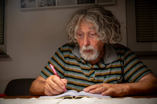 istock Thoughtful writing moment of an elderly man 2194749925