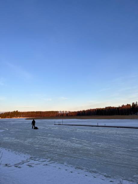 istock a man walks on ice for winter fishing 2194750522