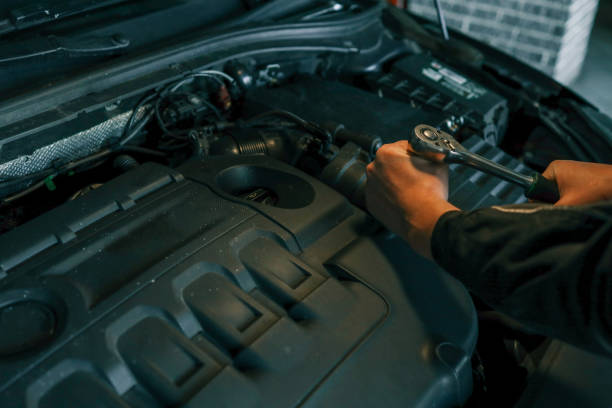 istock Mechanic's hands using a wrench to work on a TDI engine under the hood, showcasing the detailed process of automotive maintenance 2194750527