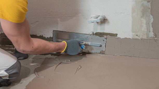 istock A worker's hand using a trowel for applies a  liquid membrane on the  the corner reinforcement tape in bathroom floor. Foolproof waterproofing for a tile bathroom. 2194752122