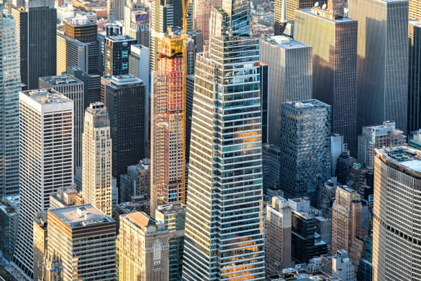 Manhattan, New York, NY, USA – September 20th, 2023 : Helicopter view over Manhattan. Between existing skyscrapers you can see a construction pit several meters deep where groundwater is located between old pools