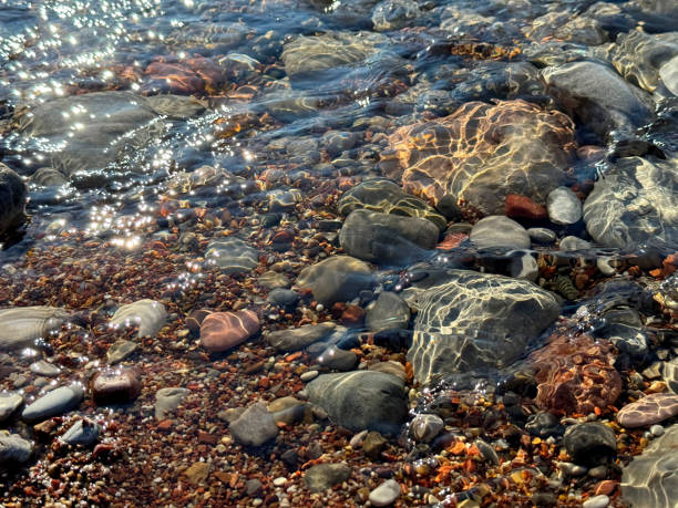 Stones and pebbles in transparent sea water.