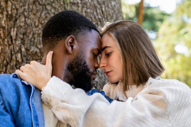 istock Multiethnic couple embracing with foreheads touching in nature 2194757530