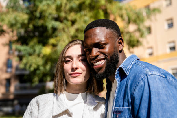 istock Happy multiethnic couple smiling at camera outdoors 2194757563