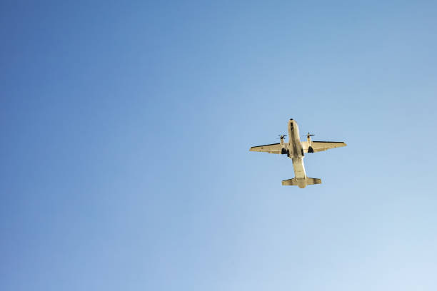 istock Small passenger airplane flying overhead against clear blue sky 2194757611