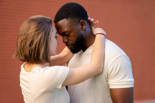istock Multiethnic couple embracing with foreheads touching gently 2194757666
