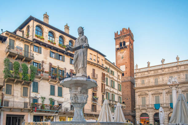 istock Italian square with fountain and Lamberti clock tower and classic architecture with ancient buildings in Verona, Veneto, Italy. Piazza delle Erbe with Fontana di Madonna. Tourist destination 2194764637
