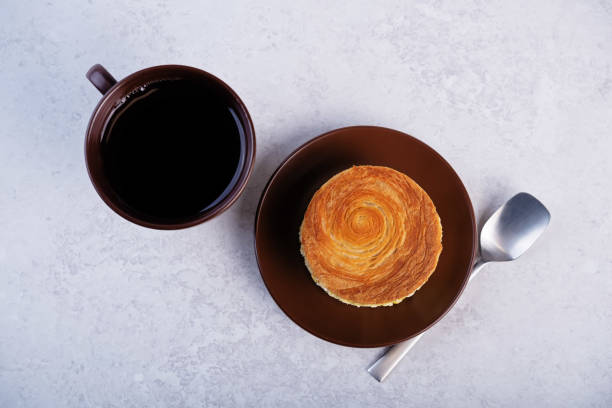 istock Croissant roll with mango in a plate on a white  background 2194767283