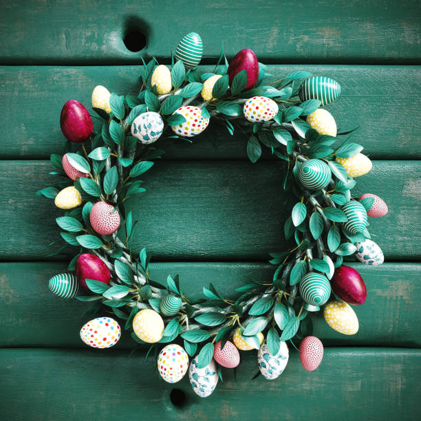 istock Beautiful Easter wreath decorated with colorful eggs on rustic green wood background with copy space. Easter concept design. 2194767464