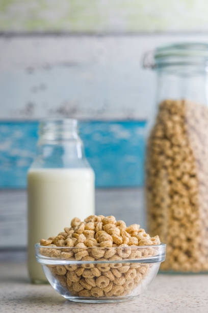 Sweet honey cereal rings in bowl on a klitchen table.