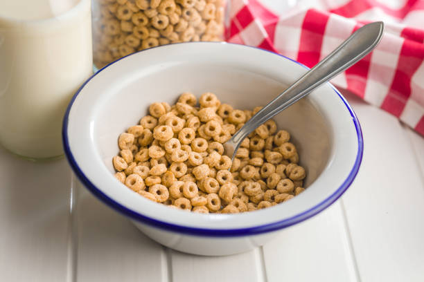istock Sweet honey cereal rings in bowl on white table. 2194768253