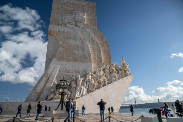 06.01.2024 Lisbon, Portugal. Lisbon’s iconic Padrão dos Descobrimentos honors the Age of Discovery, with intricate sculptures and the scenic backdrop of the river and bridge under a clear sky.