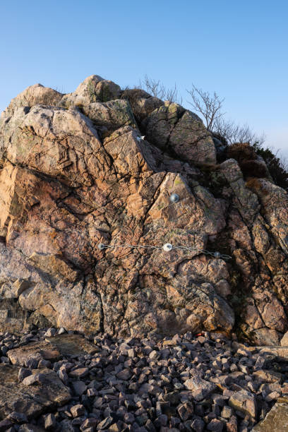 istock Brittle rock formation secured by bilts and wires. 2194771783