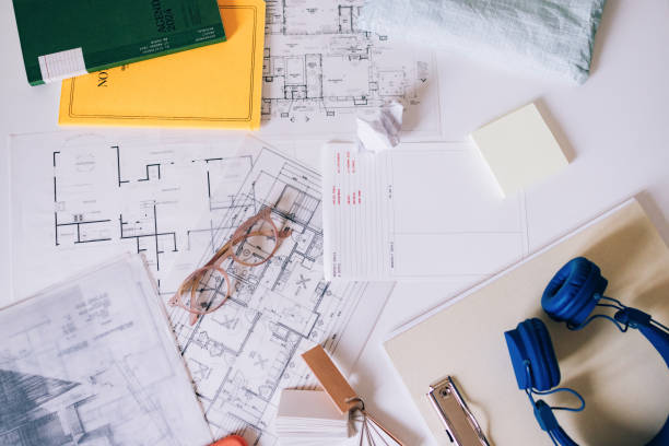 Professional workspace featuring architectural blueprints, colorful stationery, and tools reflecting creativity, organization, and productivity. Perfect setup for design, planning, or architecture-related activities in an aesthetically pleasing environment.