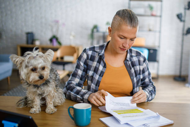 istock Beautiful woman working from home while her dog sits on the desk 2194772944