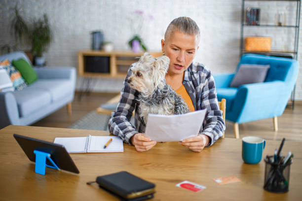 istock Woman manages her finances while spending time with her dog 2194773046