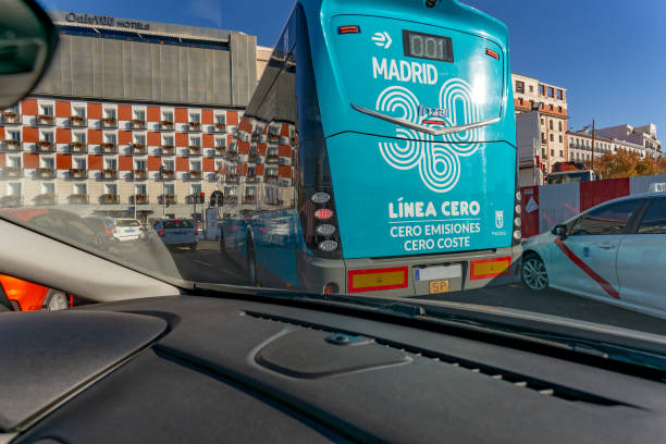 Madrid, Spain. Capturing the view from inside a car, following a zero-emissions bus on a sunny day in Madrid, Spain, showcases urban mobility in action