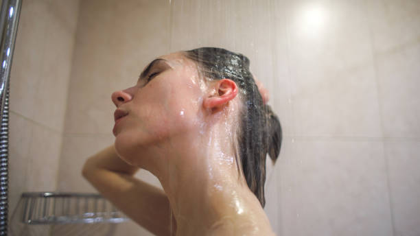 istock young beautiful woman taking shower 2194776116