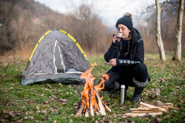 young girl drinking coffee in nature