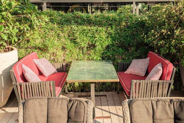 istock Outdoor seating area with red cushions and greenery background 2194780261