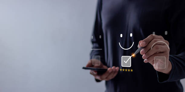 istock Excellence Review, Young Man using smartphone mobile hand with pen touching five star to review and give 5 stars with very good results in service, Good review 5 star rating choice feedback 2194782722