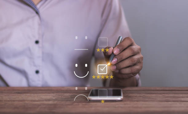 istock Experience; Review, Young Man using smartphone mobile hand with pen touching five star to review and give 5 stars with very good results in service, Good review 5 star rating choice feedback 2194782730