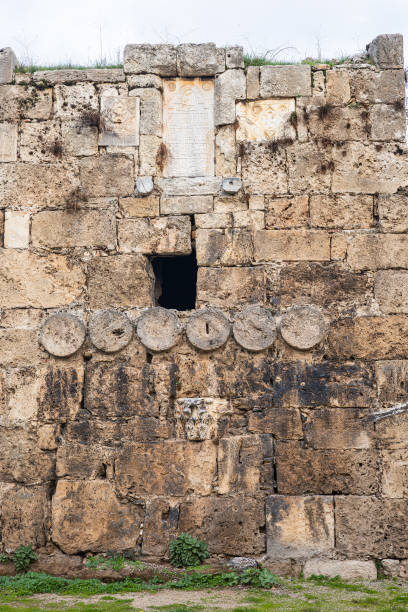 istock Ancient stone wall with historical engravings and weathered architecture 2194785401