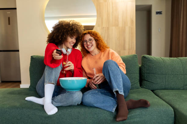 istock Female friends sitting on a sofa and having fun together 2194785827