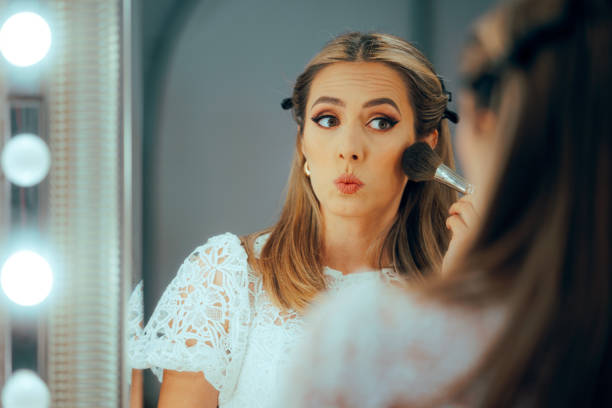 istock Woman Using a Brush to Apply Setting Powder in the Mirror 2194788061